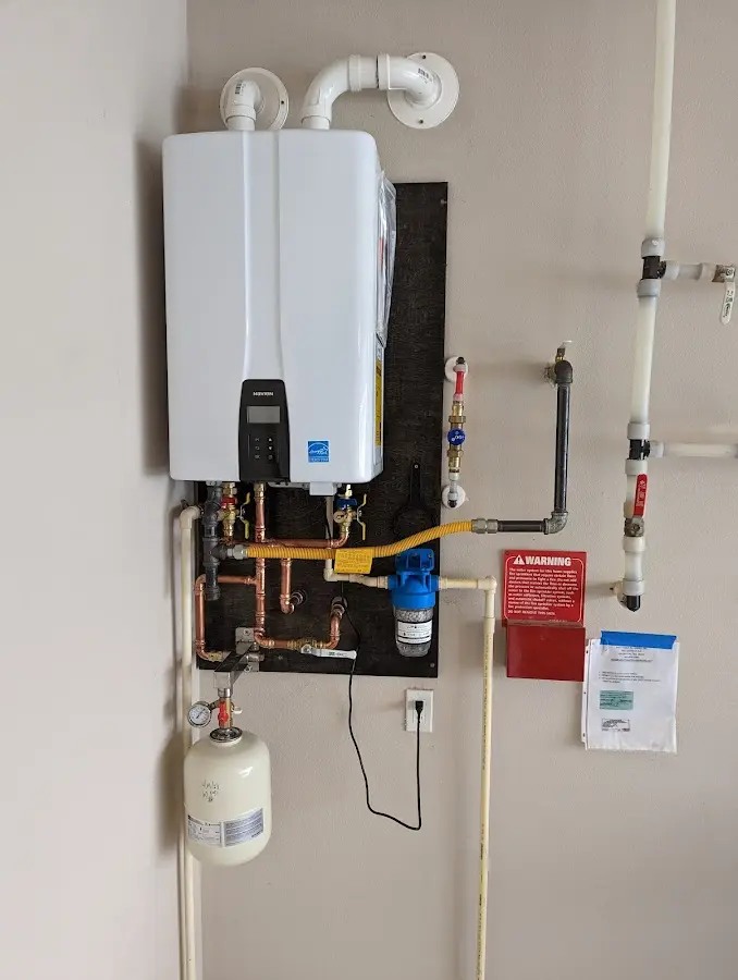 Professional plumber installing copper piping in a Lansdowne home